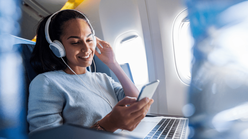 woman with over-ear noise-cancelling headphones on a plane